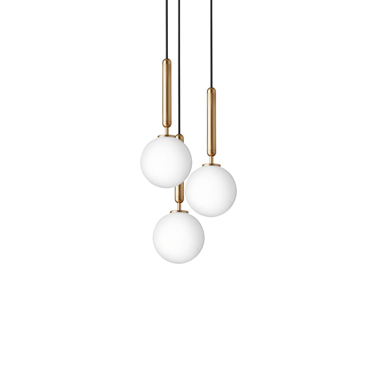 A trio of Clérachic pendants with plain white globes on brass rods, hung at staggered heights on white.