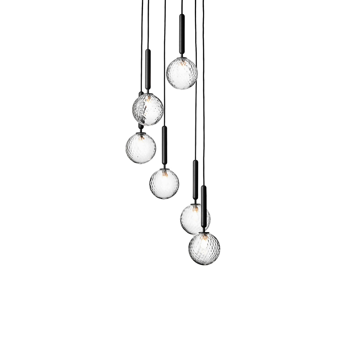 Seven Clérachic pendants with clear textured globes on black rods, cascading at different heights on white.
