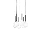 A tight trio of black-rod Clérachic pendants with white globes, hung closely together on a plain white backdrop.