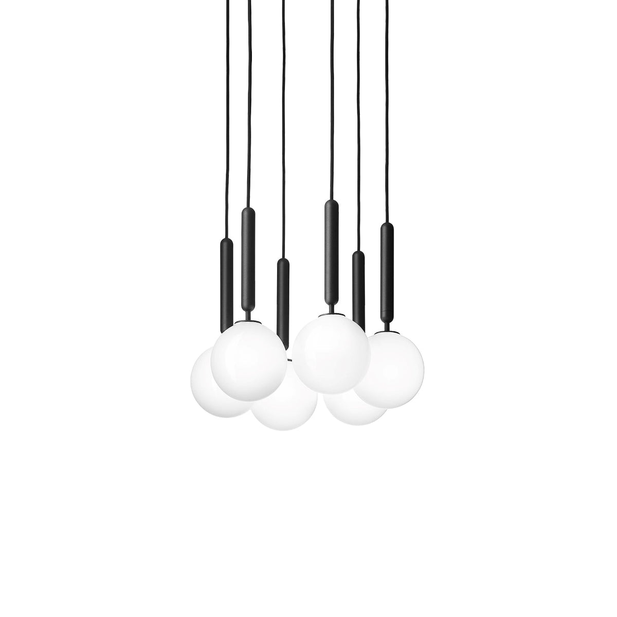 A tight trio of black-rod Clérachic pendants with white globes, hung closely together on a plain white backdrop.