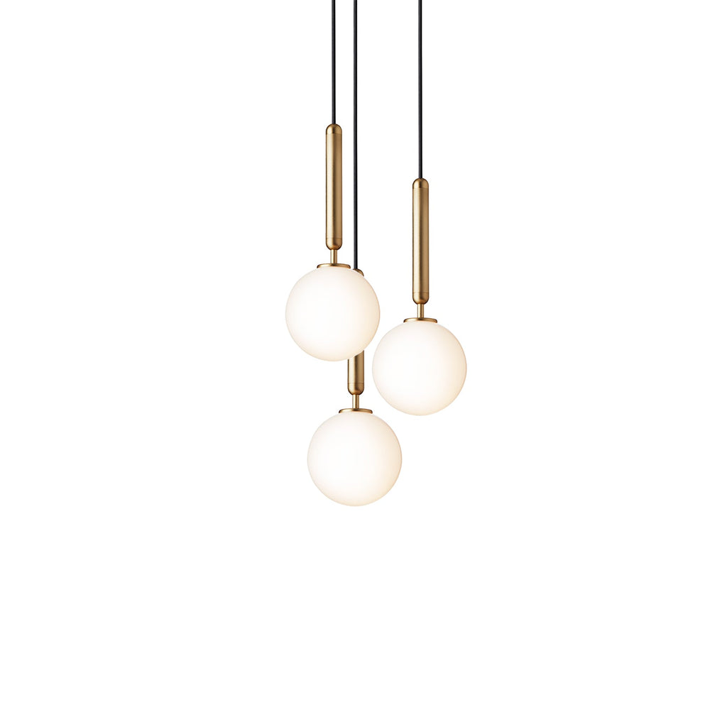 Clérachic pendant trio with white opal globes on brass rods, lit warm and hung close on a white background.