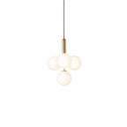 Clérachic four-globe cluster pendant with white opal globes on a brass rod, lit warm on white.