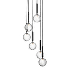 Clérachic cluster pendants with clear textured globes and black rods, shown unlit on a plain white backdrop.