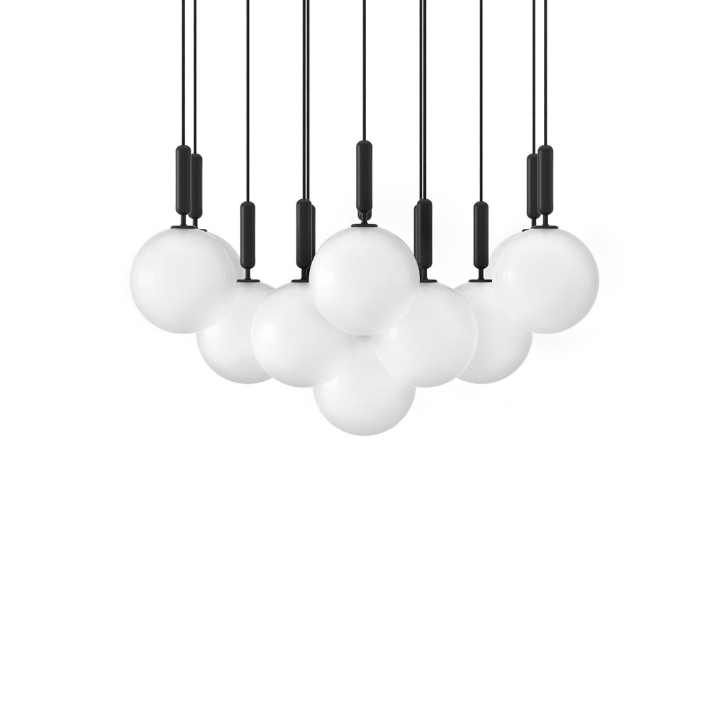 A wide, dense canopy of Clérachic pendants with white opal globes and black rods on a white background.
