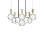 Wide Clérachic cluster of pendants with clear globes on brass rods, shown unlit on a white background.