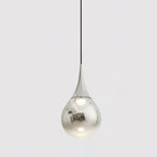 Chrome-finish Clérachic pendant with a mirrored teardrop shade, hanging from a black cord against a pale grey backdrop.