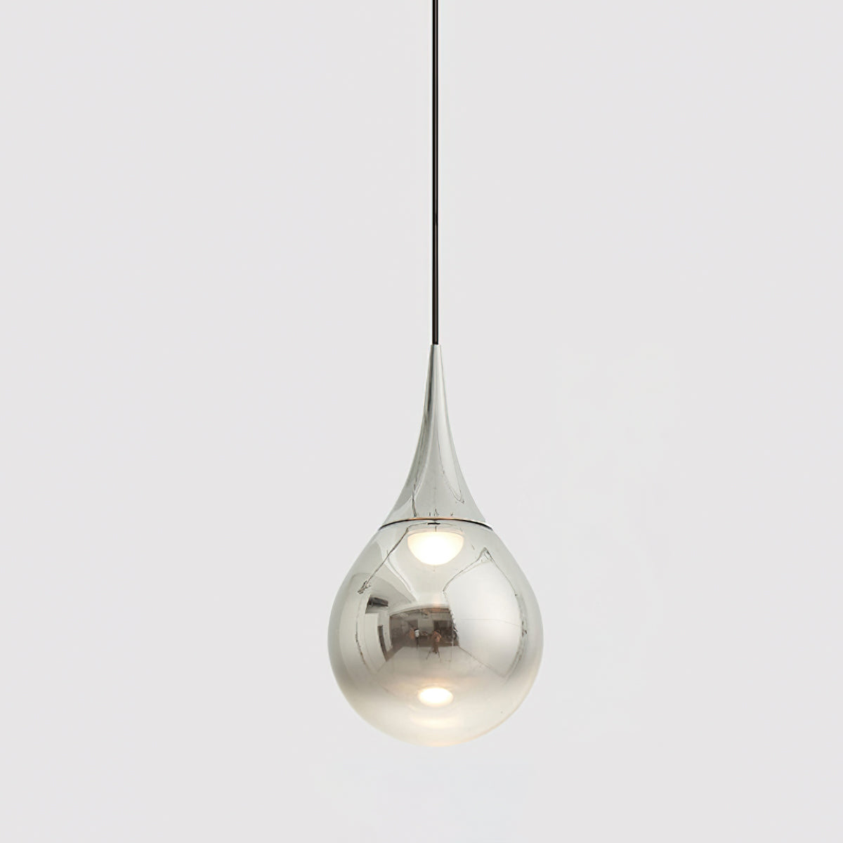 Chrome-finish Clérachic pendant with a mirrored teardrop shade, hanging from a black cord against a pale grey backdrop.