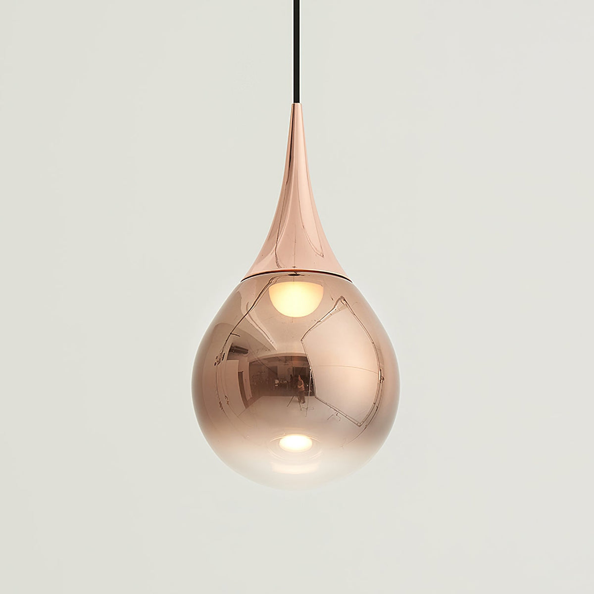 Larger view of a rose gold Clérachic pendant, its polished shade fading from copper tones to clear at the base.