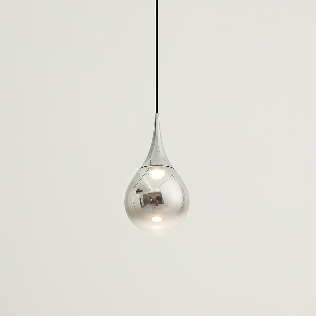 Small chrome-finish Clérachic pendant with a mirrored shade, hanging from a black cord against a pale backdrop.