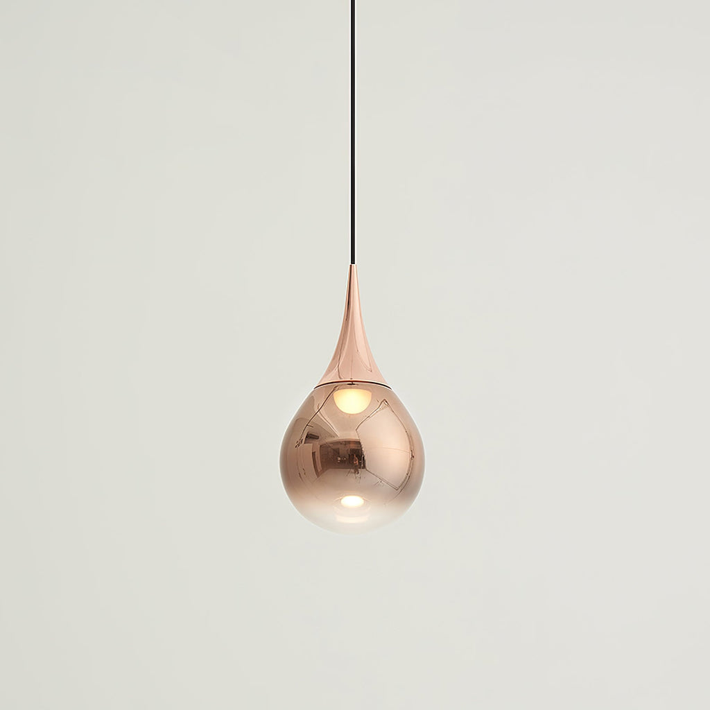 Rose gold Clérachic pendant with a copper shade fading to clear, set against a soft off-white wall.