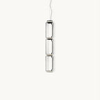 Three stacked clear glass cylinders with dark rings, this Clérachic pendant hanging on a thin cable against a plain white backdrop.