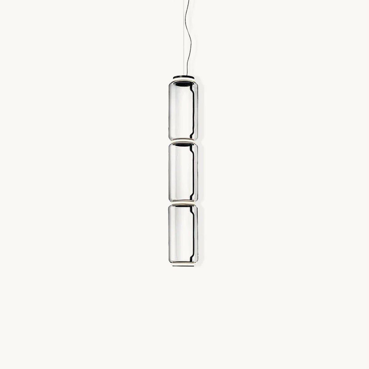 Three stacked clear glass cylinders with dark rings, this Clérachic pendant hanging on a thin cable against a plain white backdrop.