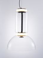 Glass cylinder with a lit ring above a clear dome, this Clérachic pendant on a pale grey backdrop with a black cable.
