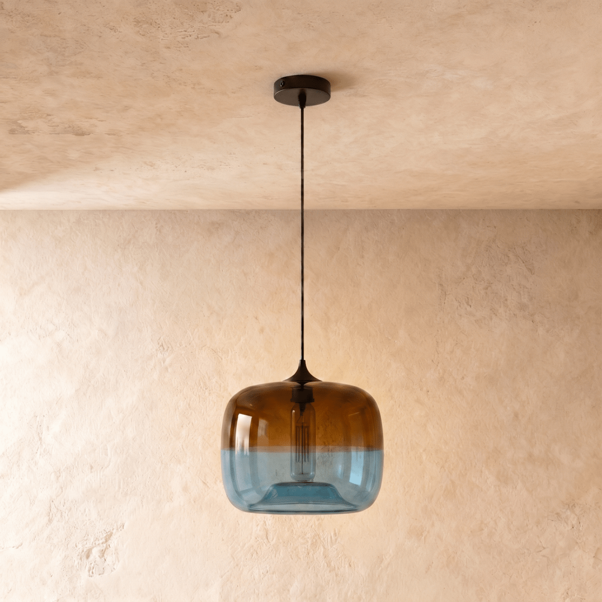 Clérachic amber-to-blue glass pendant switched off, showing the clear tubular bulb inside, on a black cord and canopy.