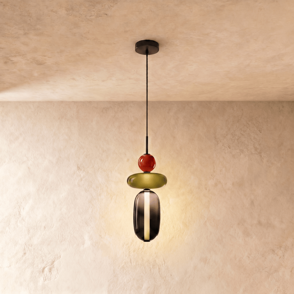 Clérachic pendant with a red bead, olive glass disc and smoked glass capsule below, lit on a slim black cord.