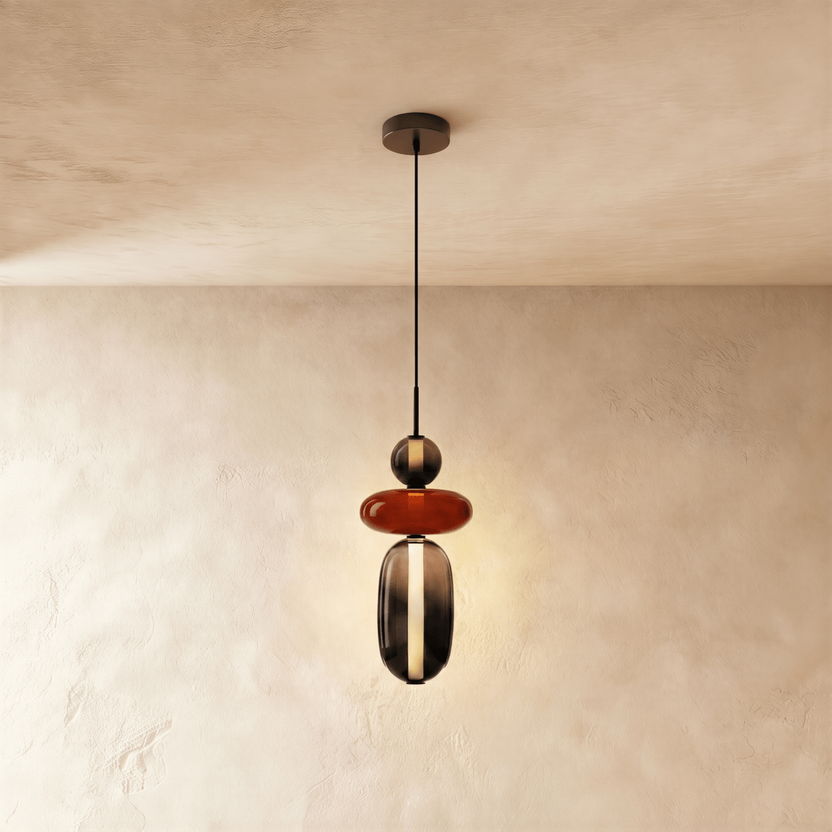 Clérachic pendant combining a smoked glass bead, a flat terracotta-red disc and a tall smoked capsule with a light strip.