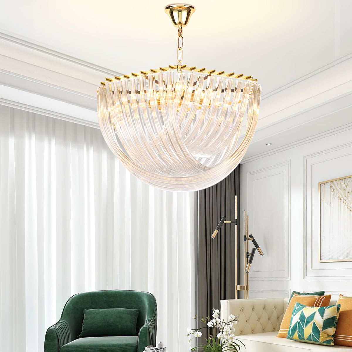 Large Clérachic glass chandelier above a living room with white curtains, a green armchair and a patterned cushion sofa.