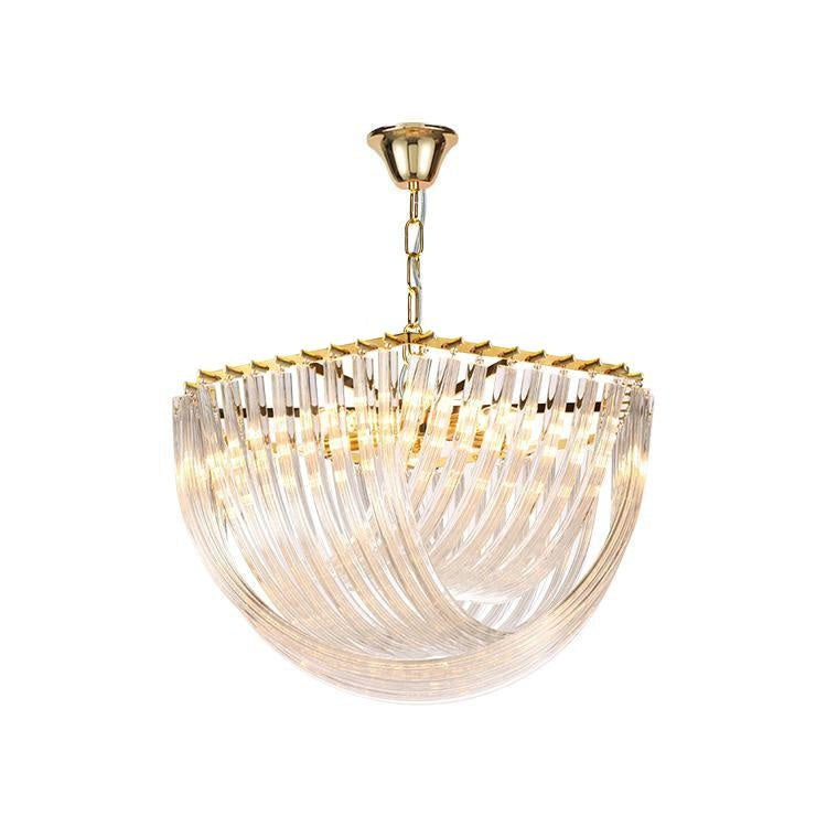 Gold-framed Clérachic chandelier with curved clear glass rods lit warmly from within, hung from a gold chain on white.