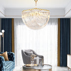 Clérachic chandelier shown from below, hung in front of navy and gold curtains, a sheer window and a grey armchair.