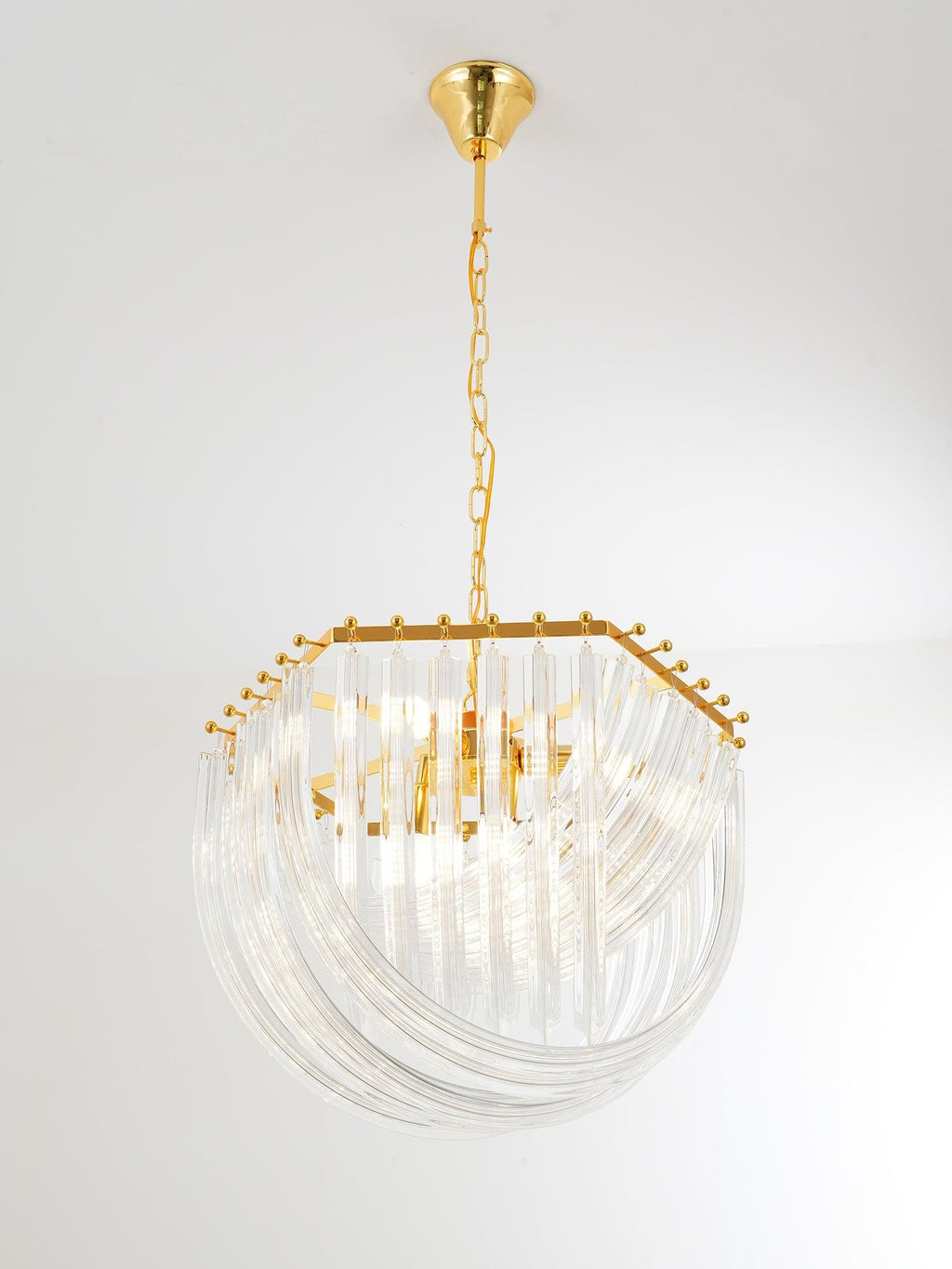 Clérachic chandelier with a gold canopy, long chain and hexagonal gold frame, its glass rods looping below on a pale backdrop.