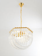 Clérachic chandelier with a gold canopy, long chain and hexagonal gold frame, its glass rods looping below on a pale backdrop.