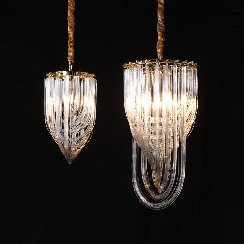 Two narrow looped-glass Clérachic chandeliers of different sizes, lit on twisted cords against a black backdrop.