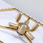 Underside of the gold frame of this Clérachic chandelier, showing six gold lamp holders around the central hub.