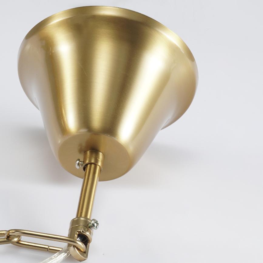 Close view of the brushed gold ceiling canopy, rod and chain link at the top of this Clérachic chandelier.