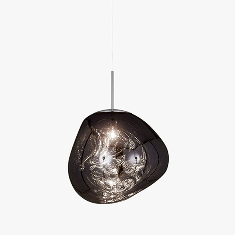 A Clérachic smoke-grey glass pendant on a pale backdrop, with its lit bulb showing through a swirled, uneven shade.