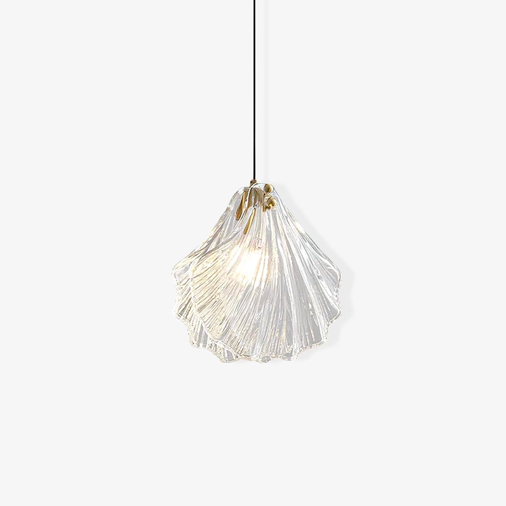 Studio view of a Clérachic shell pendant with layered ribbed clear glass and a small brass cap, on a plain white background.