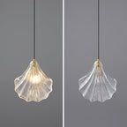 Two views side by side of a Clérachic shell pendant on grey, lit on the left and switched off on the right.