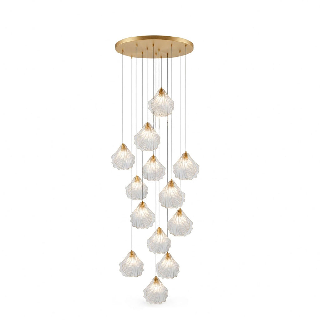 A tall cluster of clear glass shell pendants from Clérachic hangs from a round brass ceiling plate, on a white background.