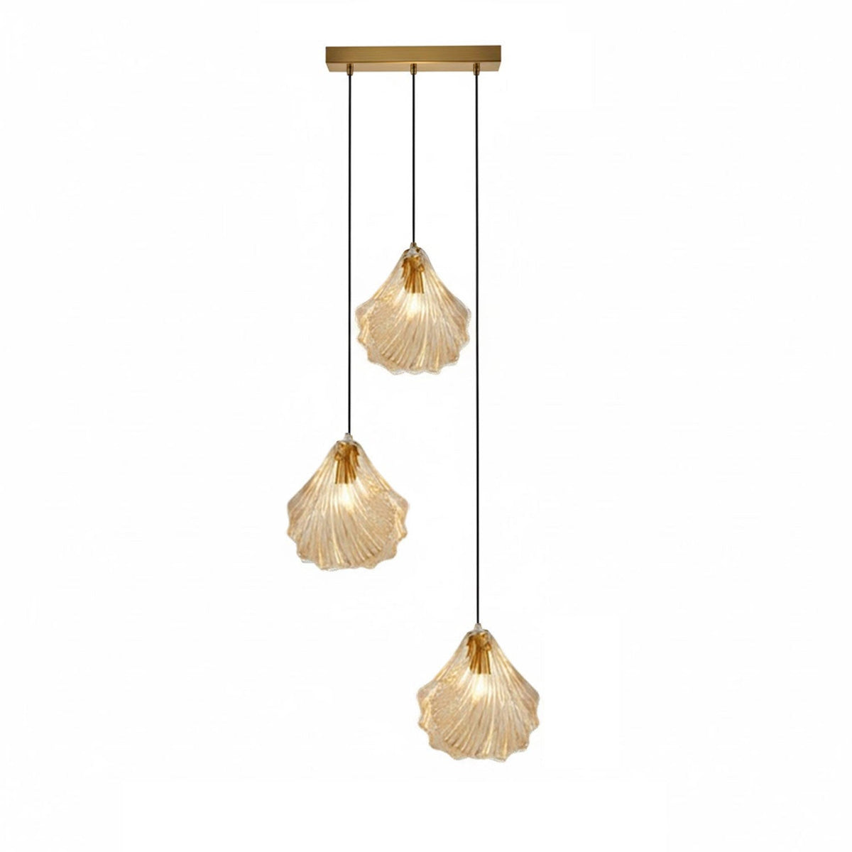 A Clérachic three-light pendant with cognac glass shells hangs at three lengths from a straight brass bar, on white.