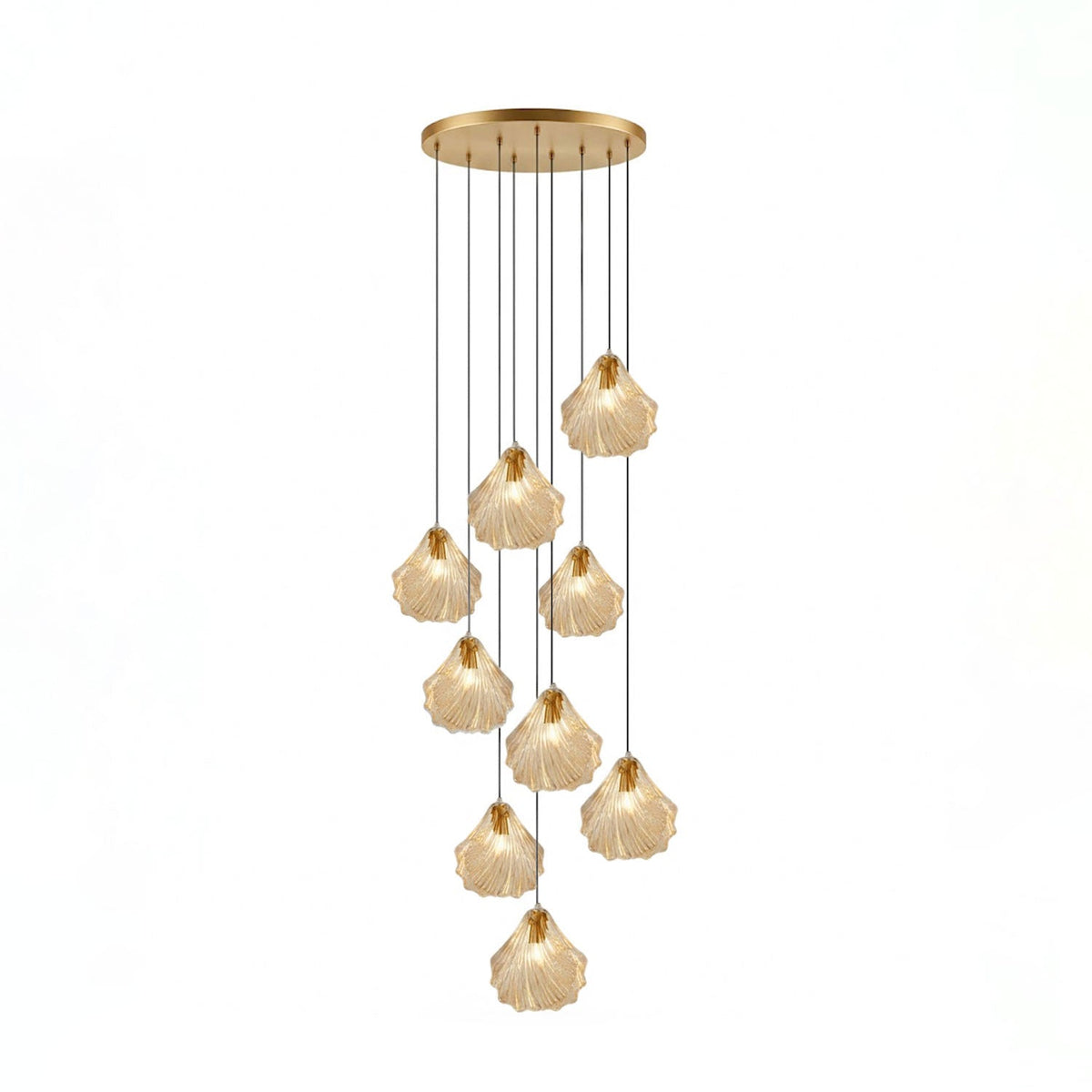 A Clérachic cluster of nine cognac glass shell pendants hangs at different lengths from a round brass ceiling plate.