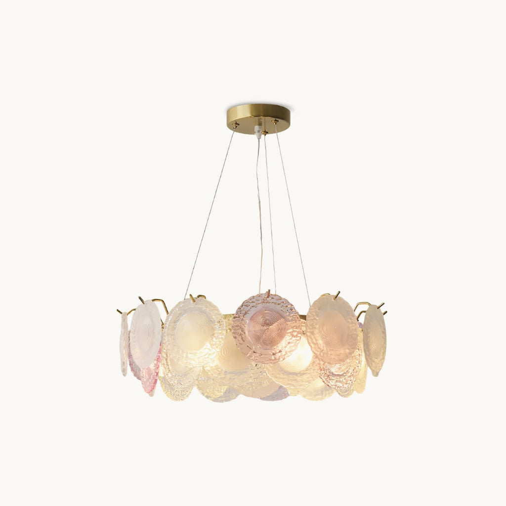A Clérachic round pendant with a ring of overlapping pink and frosted glass discs on a gold frame, hung from three wires, on a white backdrop.