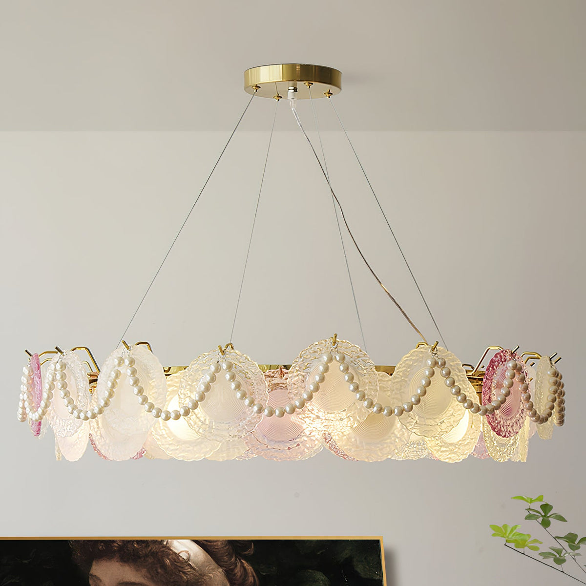 A Clérachic pendant with pearl swags and a wide ring of glass discs, on wires, with a portrait painting beneath.