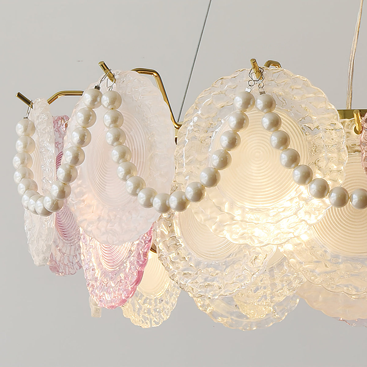 Close view of the pearl strands and the ridged, frosted glass discs on this Clérachic pendant.