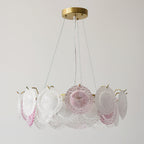 A Clérachic ring pendant of frosted and pink glass discs on a brass canopy, unlit, against a light grey wall.