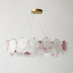 The Clérachic pendant, switched off, hung on three wires with a flatter ring of frosted and pink glass discs.