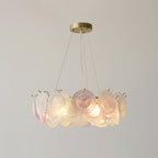 This Clérachic ring pendant lit on a grey backdrop, with a pink disc at the centre front and frosted ones round it.