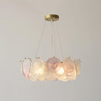 Clérachic pendant of frosted and pink glass discs, lit, with a compact ring shape on a pale grey backdrop.