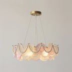 This Clérachic pendant with pearl swags, lit, with a pink disc at the front and frosted ones round the ring.