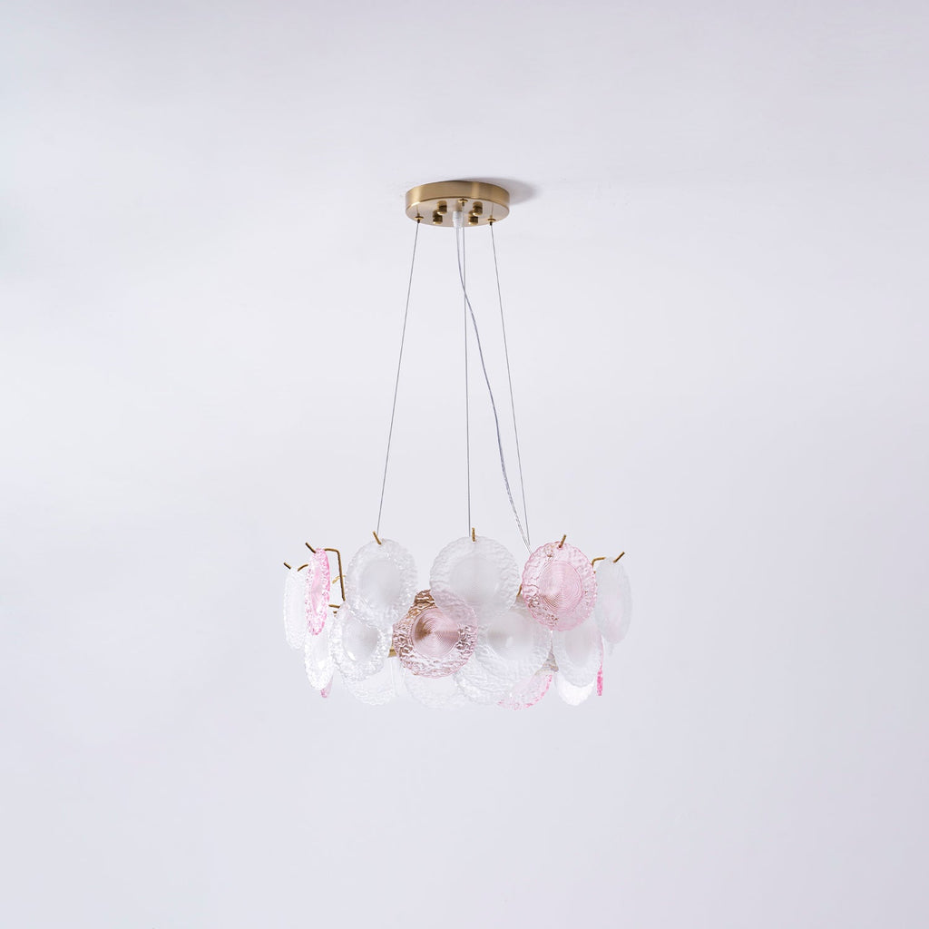 A smaller Clérachic pendant of pink and frosted glass discs, seen on a pale lilac backdrop.