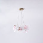A smaller Clérachic pendant of pink and frosted glass discs, seen on a pale lilac backdrop.