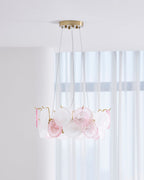 Clérachic pendant with pink and frosted glass discs, seen from slightly below, in front of tall white curtains.