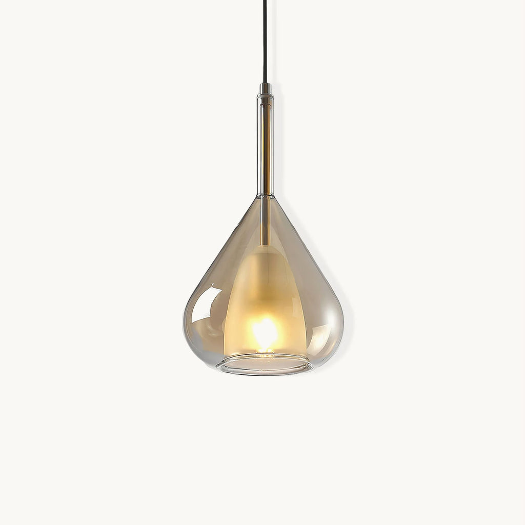 Amber glass teardrop pendant from Clérachic on a plain white backdrop, with a frosted inner shade lit warm and a slim brass stem above.