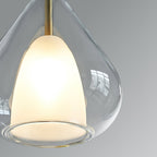 Close view of the frosted white inner shade and clear outer glass of this Clérachic pendant, with a brass stem above.