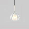 Transparent glass teardrop pendant from Clérachic on a pale grey backdrop, with a lit frosted inner shade and a slim light-coloured stem.