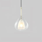 Transparent glass teardrop pendant from Clérachic on a pale grey backdrop, with a lit frosted inner shade and a slim light-coloured stem.