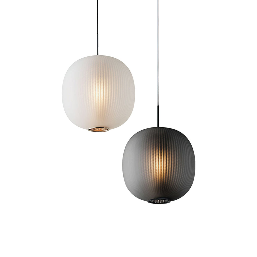 Matte white and smoke-grey Clérachic ribbed pendants shown together on a white backdrop, both lit warmly.